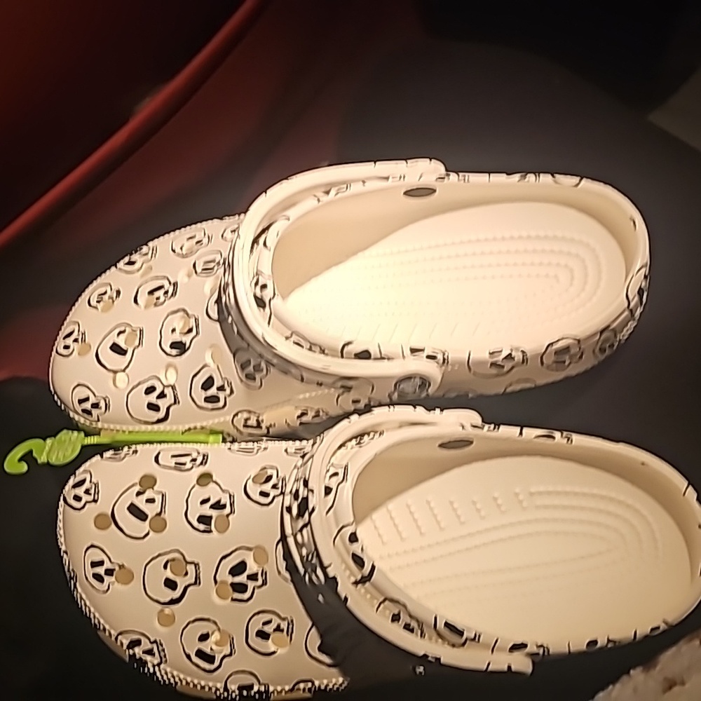 White and black skull crocs